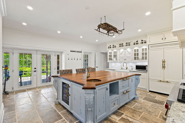 Custom chef's kitchen with furniture-style island