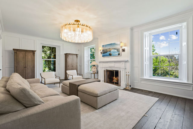 Serene living room with fireplace and heritage windows